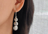 Triple-shell silver drop earrings
